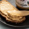 Close-up van romige cashewpasta op een snee meergranenbrood