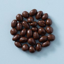 Biologische melkchocolade pinda's van bovenaf op een lichte achtergrond.