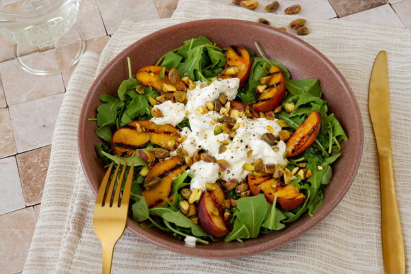 Gegrilde perziksalade met burrata, pistachenoten & honing-citroendressing